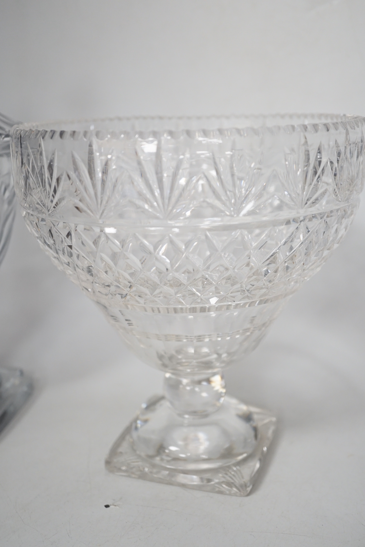 A pair of Regency Irish cut glass sweetmeat vases and covers, 30cm high and an Edwardian cut glass pedestal vase (3)
